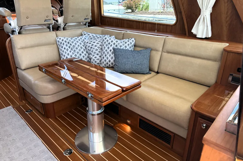 Slide: The Image of Luxurious interior of 2022 Sabre 48 Salon Express with elegant seating and polished wood table. - 16