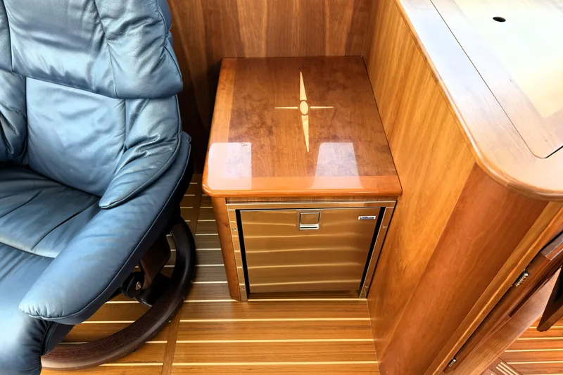 Slide: The Image of Luxurious interior of 2022 Sabre 48 Salon Express with leather chair and wooden cabinetry. - 20