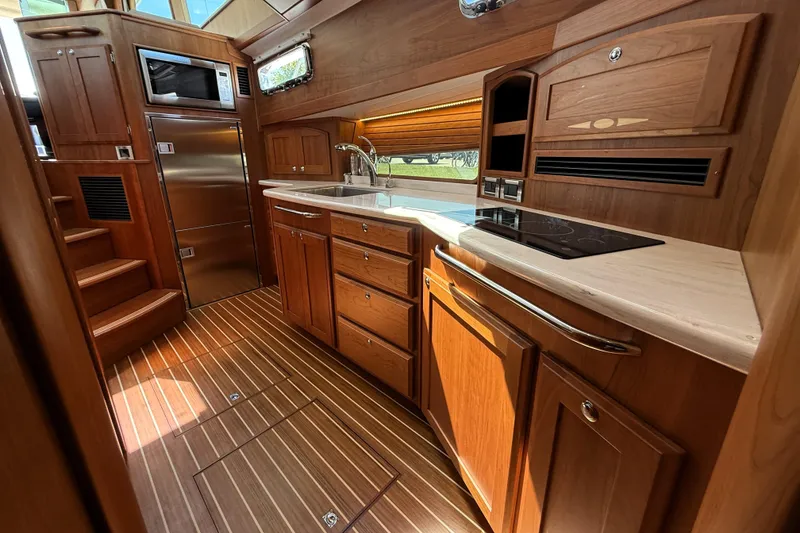 Slide: The Image of Luxurious 2022 Sabre 48 Salon Express yacht interior with elegant wood cabinetry and modern appliances. - 31