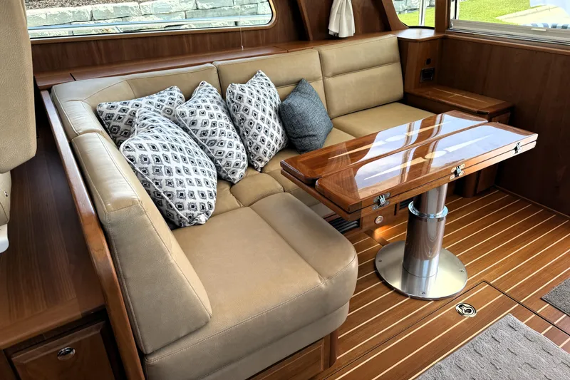 Slide: The Image of Luxurious interior of 2022 Sabre 48 Salon Express with plush seating and elegant wooden table. - 18