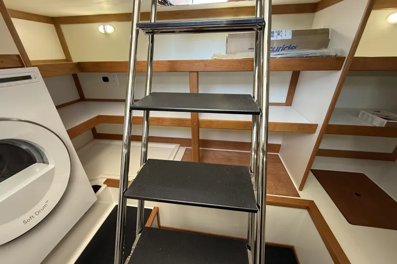 Slide: The Image of Interior of 2022 Sabre 48 Salon Express with ladder and washer. - 40