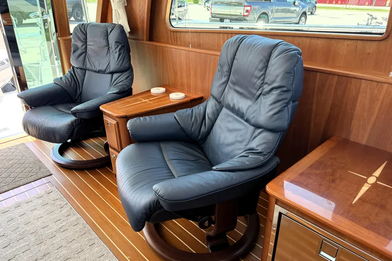 Slide: The Image of Luxurious interior of 2022 Sabre 48 Salon Express with plush leather chairs and wooden accents. - 14