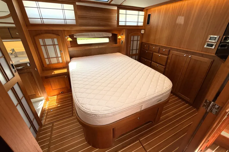 Slide: The Image of Luxurious bedroom interior of 2022 Sabre 48 Salon Express yacht with wooden finishes. - 33