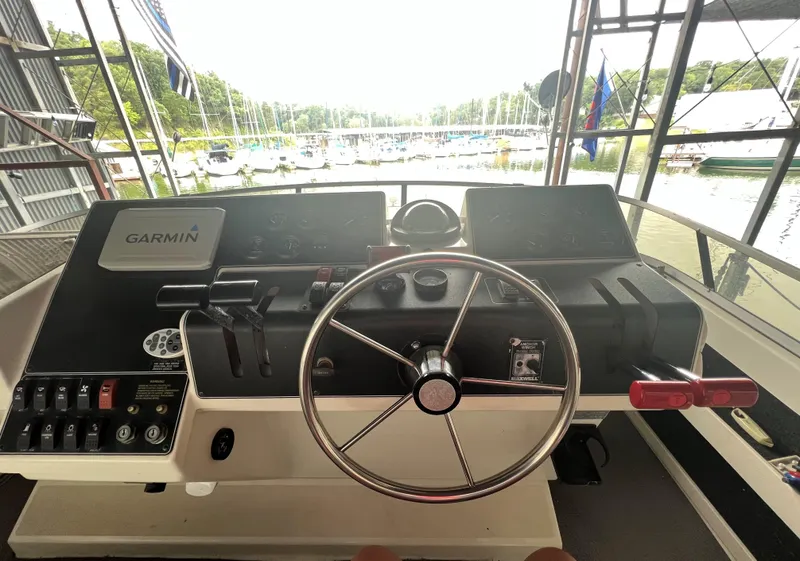 Slide: The Image of 1994 Carver 350 Aft Cabin helm with Garmin navigation system, docked at marina. - 10