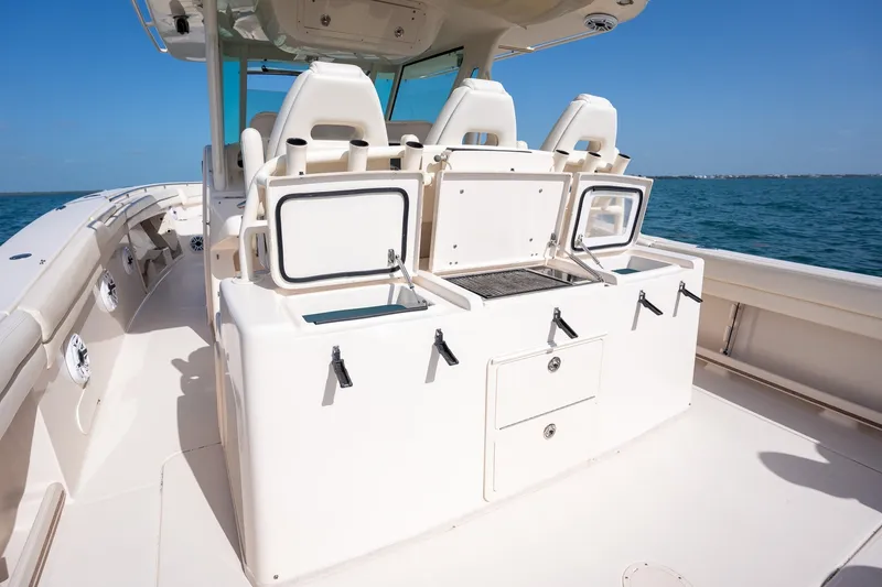 Slide: The Image of 2015 Grady-White Canyon 376 boat interior with seating and storage, on open water. - 35