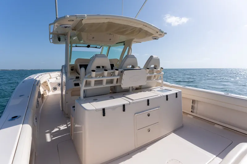 Slide: The Image of 2015 Grady-White Canyon 376 boat interior, featuring helm seating and ocean view. - 15