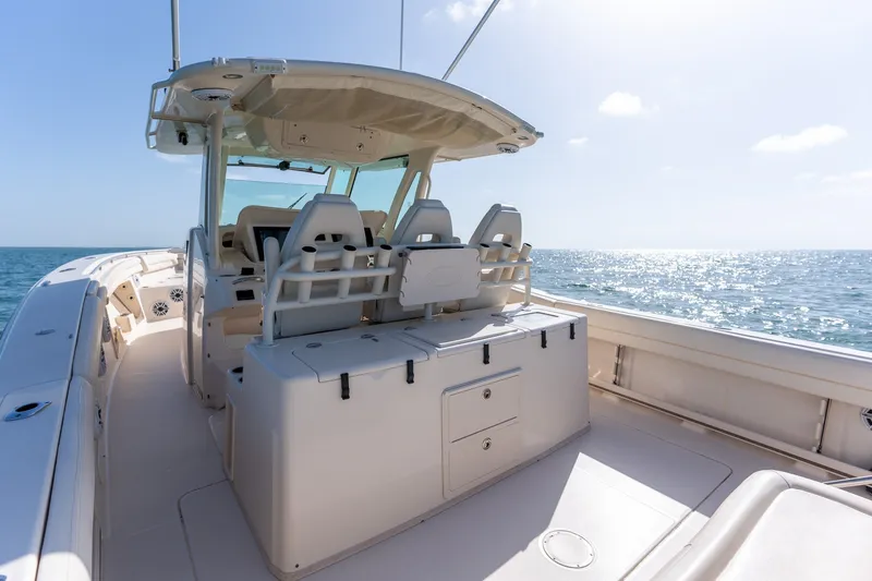 Slide: The Image of 2015 Grady-White Canyon 376 boat interior with ocean view, featuring helm seating and storage. - 16