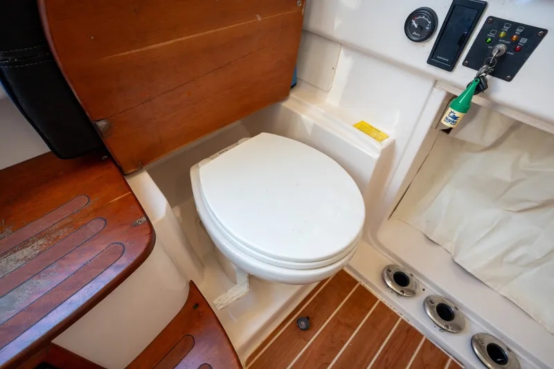Slide: The Image of 2015 Grady-White Canyon 376 boat interior with toilet and wooden flooring. - 30