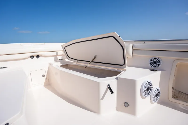 Slide: The Image of 2015 Grady-White Canyon 376 boat interior with open storage compartment and speakers. - 23