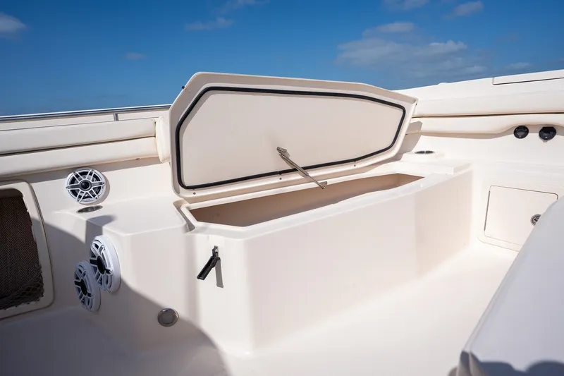 Slide: The Image of 2015 Grady-White Canyon 376 boat interior with open storage compartment and speakers. - 24