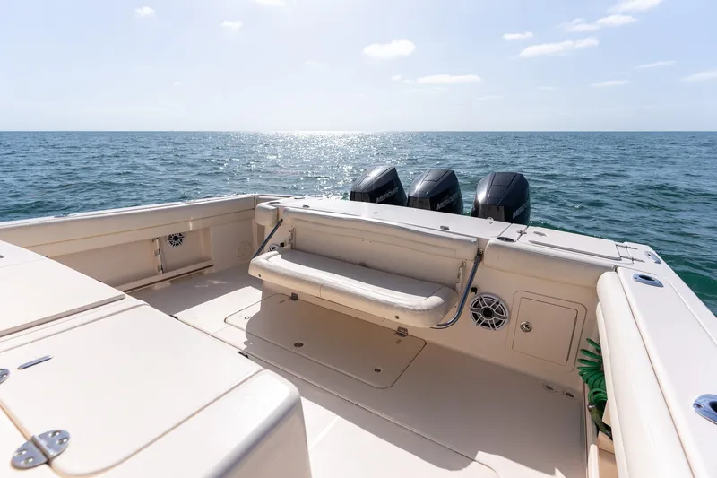 Slide: The Image of 2015 Grady-White Canyon 376 boat with triple Mercury engines on open sea. - 17