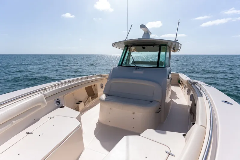 Slide: The Image of 2015 Grady-White Canyon 376 boat on open sea under clear sky. - 21