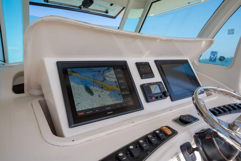 Slide: The Image of Dashboard of 2015 Grady-White Canyon 376 boat with navigation screens and controls. - 19
