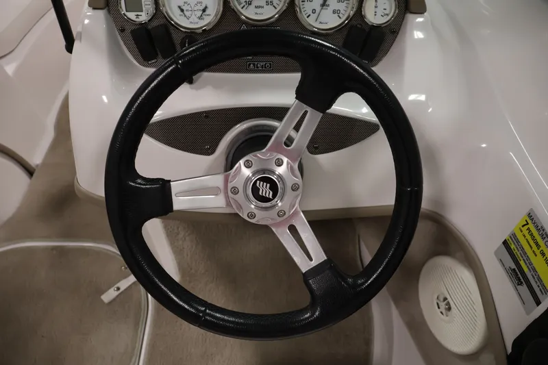 Slide: The Image of Steering wheel and dashboard of 2009 Four Winns H180 boat. - 18