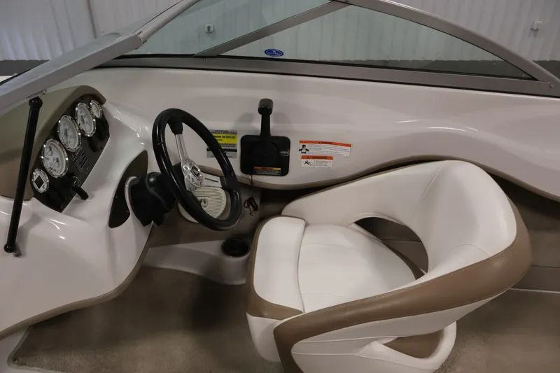 Slide: The Image of 2009 Four Winns H180 boat interior with steering wheel and gauges. - 16