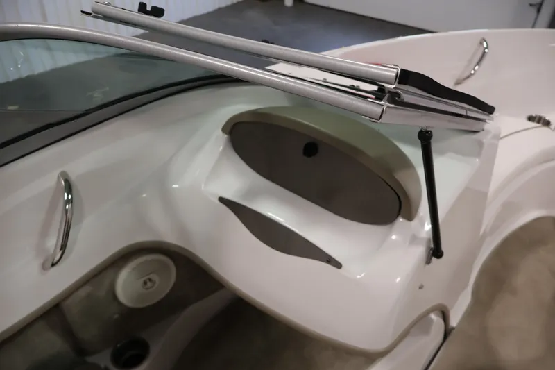 Slide: The Image of Interior view of a 2009 Four Winns H180 boat, showcasing dashboard and windshield details. - 25