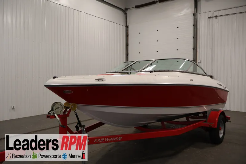 The Image of 2009 Four Winns H180 boat on trailer in indoor showroom. - 1