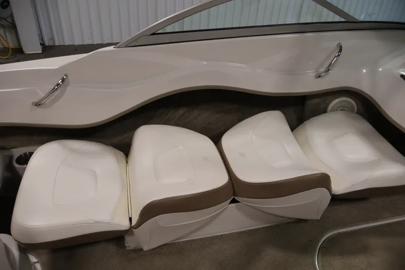 Slide: The Image of 2009 Four Winns H180 boat interior with white cushioned seating and sleek design. - 29