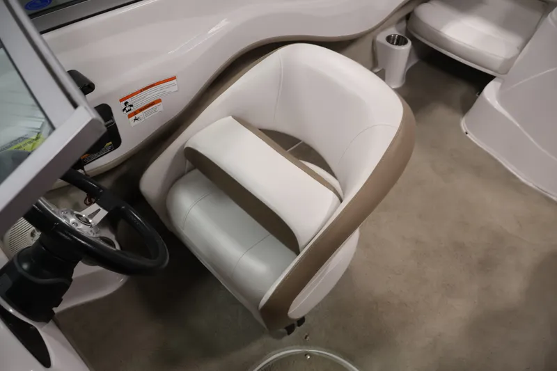 Slide: The Image of 2009 Four Winns H180 boat interior with white and beige seating. - 24