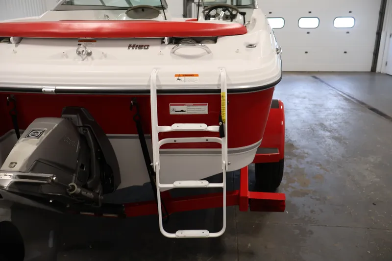 Slide: The Image of 2009 Four Winns H180 boat with ladder and outboard motor in a garage. - 36