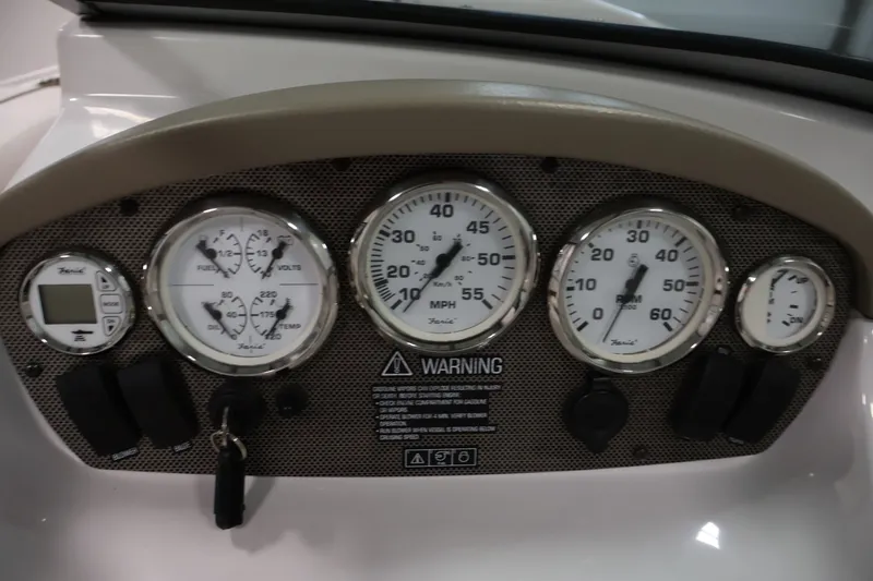 Slide: The Image of Dashboard of a 2009 Four Winns H180 boat with gauges and controls. - 19