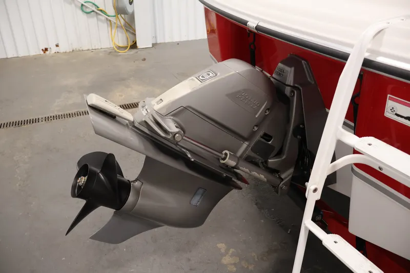 Slide: The Image of 2009 Four Winns H180 boat with visible outboard motor and propeller in a garage. - 37