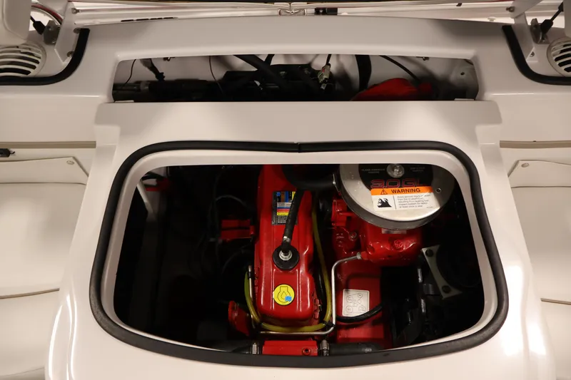 Slide: The Image of Engine compartment of a 2009 Four Winns H180 boat, showcasing a red engine. - 33