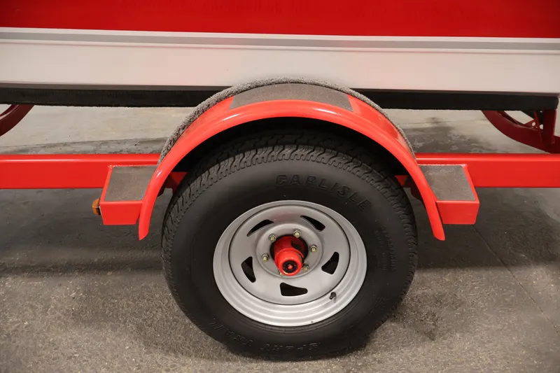 Slide: The Image of Red trailer wheel of a 2009 Four Winns H180 boat. - 43