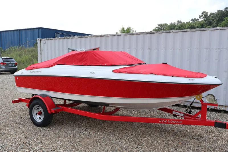 Slide: The Image of 2009 Four Winns H180 boat with red cover on a matching trailer. - 44
