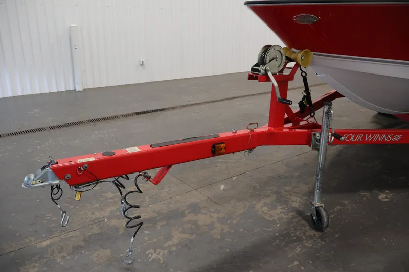 Slide: The Image of Red trailer hitch of 2009 Four Winns H180 boat in a garage setting. - 41