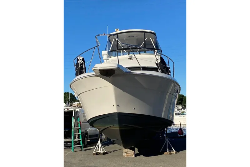 Slide: The Image of 2001 Silverton 42 Convertible yacht on dry dock under clear blue sky. - 2