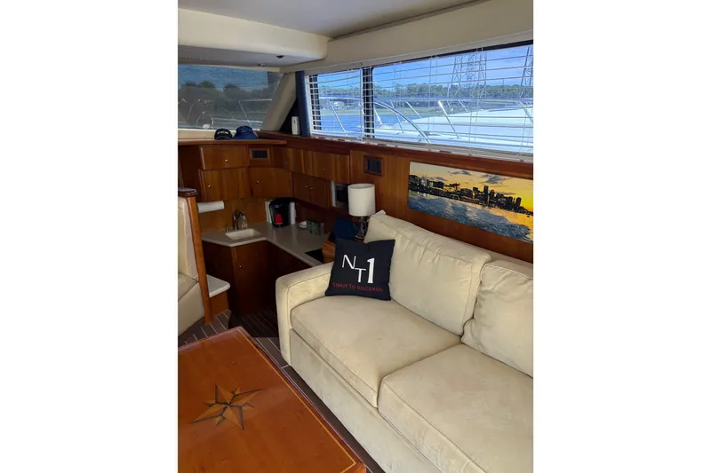 Slide: The Image of Interior of 2001 Silverton 42 Convertible yacht with beige sofa and wooden cabinetry. - 12