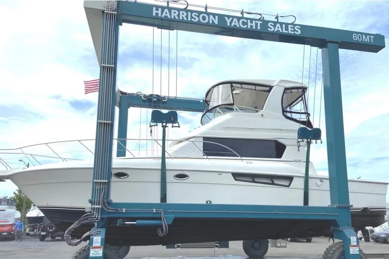 Slide: The Image of 2001 Silverton 42 Convertible yacht on lift at Harrison Yacht Sales. - 1