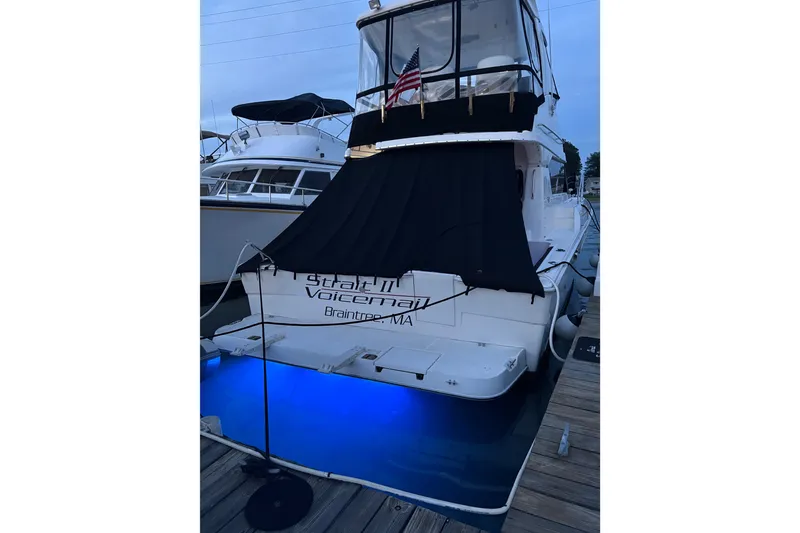 Slide: The Image of 2001 Silverton 42 Convertible yacht docked with blue underwater lights. - 9