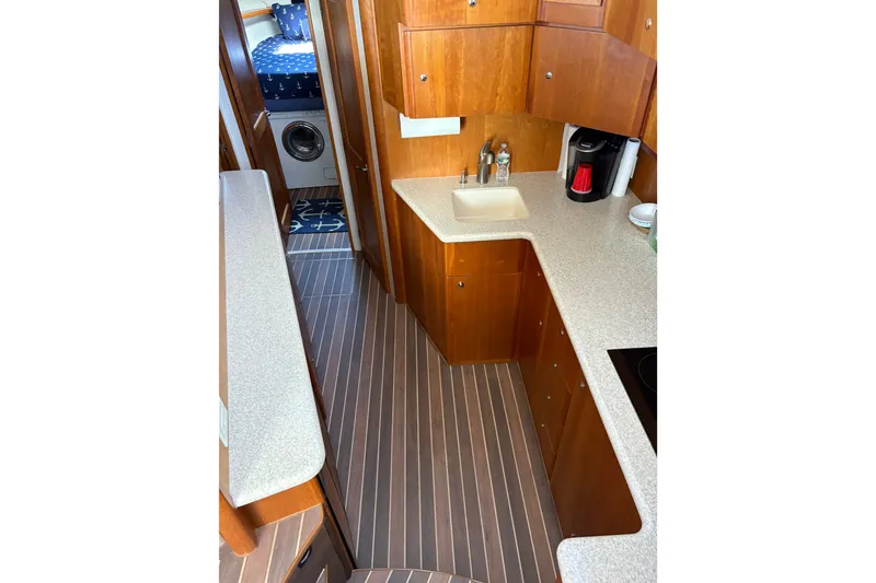 Slide: The Image of Interior of 2001 Silverton 42 Convertible yacht with modern kitchen and cozy cabin. - 15