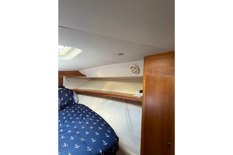 Slide: The Image of Cozy cabin interior of 2001 Silverton 42 Convertible yacht with nautical bedding. - 18