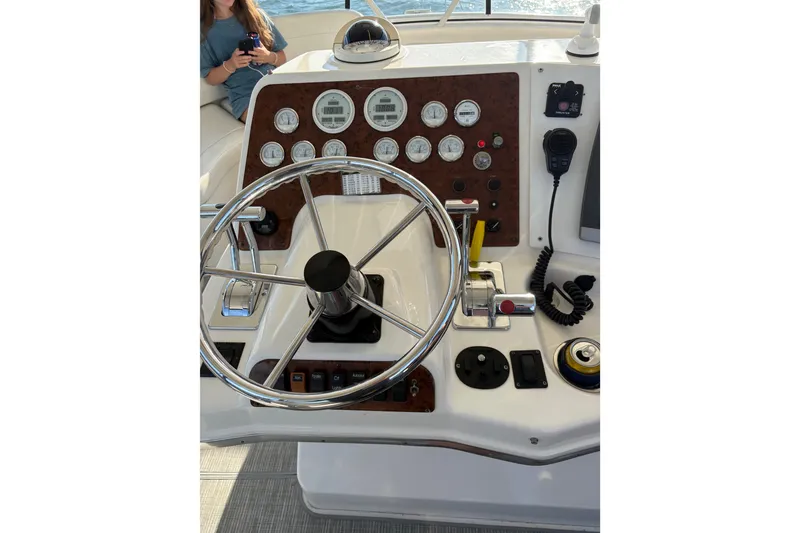 Slide: The Image of Helm of 2001 Silverton 42 Convertible yacht with steering wheel and control panel. - 25