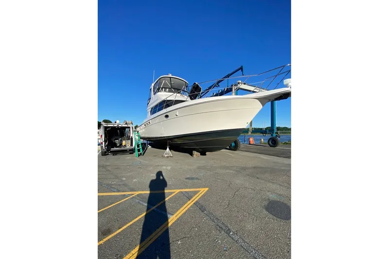 Slide: The Image of 2001 Silverton 42 Convertible yacht on dry dock under clear blue sky. - 7