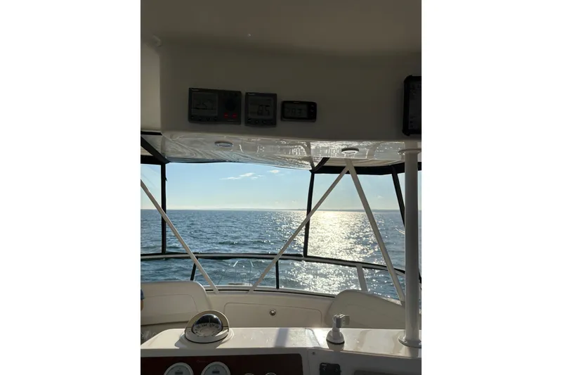 Slide: The Image of 2001 Silverton 42 Convertible yacht interior with ocean view through the cockpit. - 24