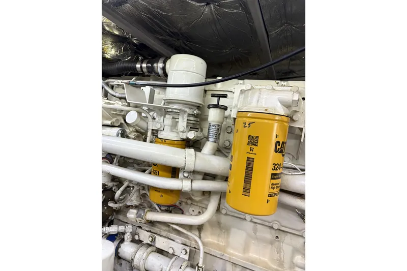 Slide: The Image of Engine compartment of a 2001 Silverton 42 Convertible with visible filters and pipes. - 33