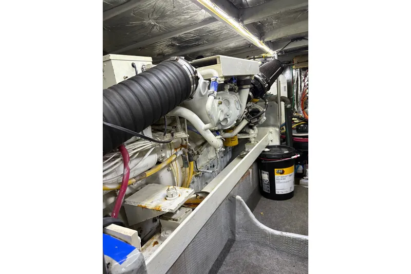 Slide: The Image of Engine room of a 2001 Silverton 42 Convertible yacht, showcasing mechanical components. - 32