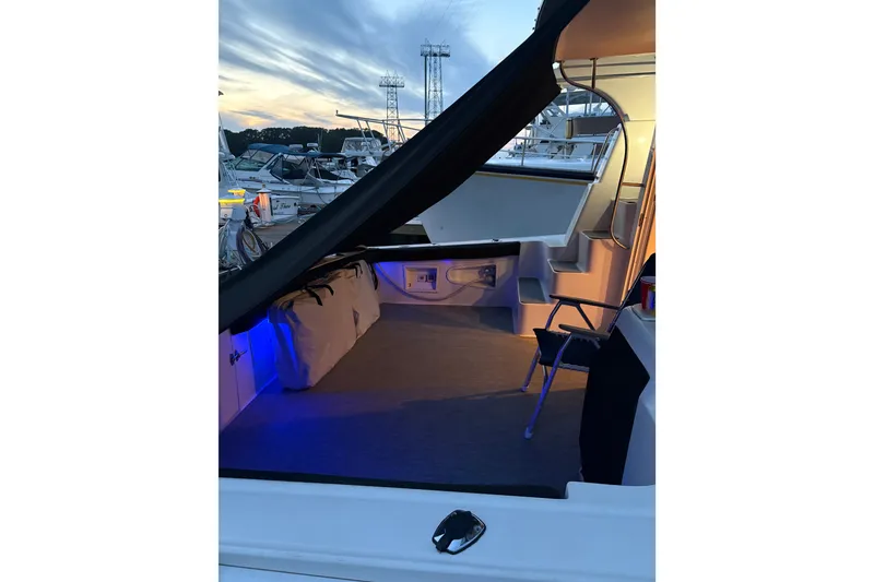 Slide: The Image of 2001 Silverton 42 Convertible yacht interior with blue lighting at sunset. - 11