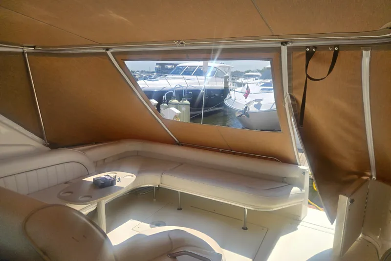 Slide: The Image of Interior view of 1999 Sea Ray 450 Sundancer yacht with seating and window. - 14