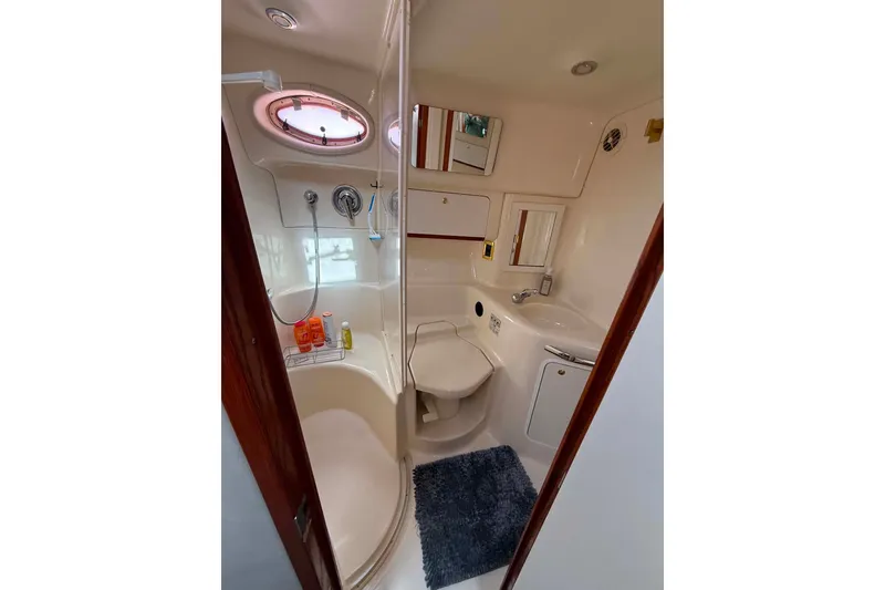 Slide: The Image of Bathroom interior of 1999 Sea Ray 450 Sundancer yacht, featuring shower and sink. - 18