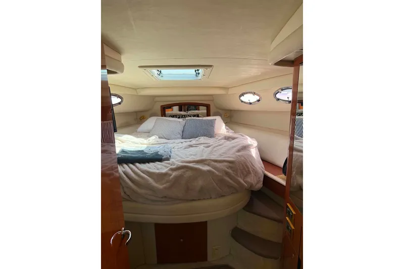 Slide: The Image of Cozy cabin interior of 1999 Sea Ray 450 Sundancer yacht with plush bedding. - 15