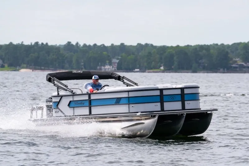 The Image of 2027 Bentley Pontoons 223 Bolt Tri-Toon cruising on a scenic lake. - 3