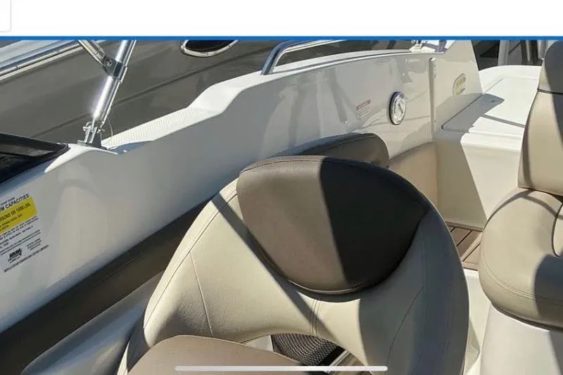 Slide: The Image of 2017 Bayliner 190 Deck Boat interior with beige seating and sleek design. - 5