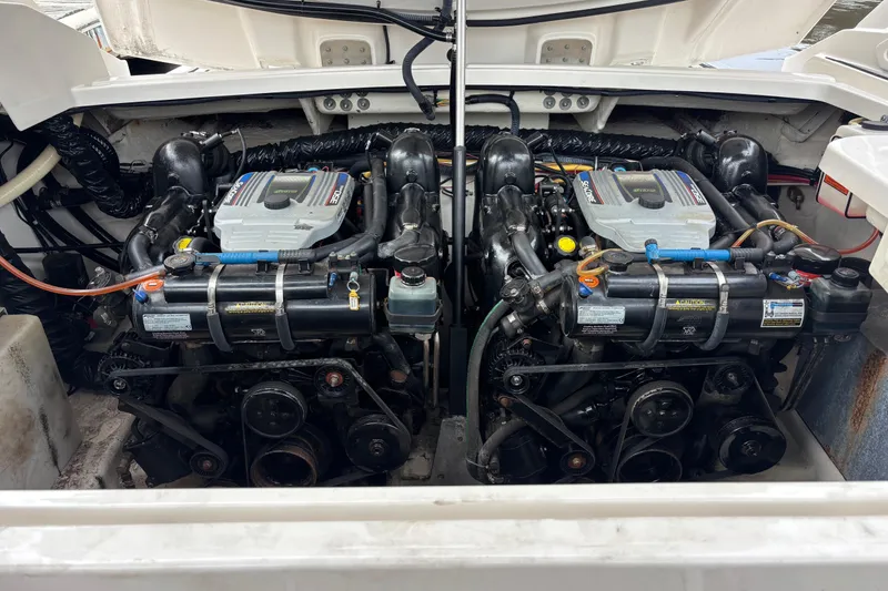 Slide: The Image of Twin engines in a 2014 Monterey 328SS Super Sport boat, showcasing detailed mechanics. - 35