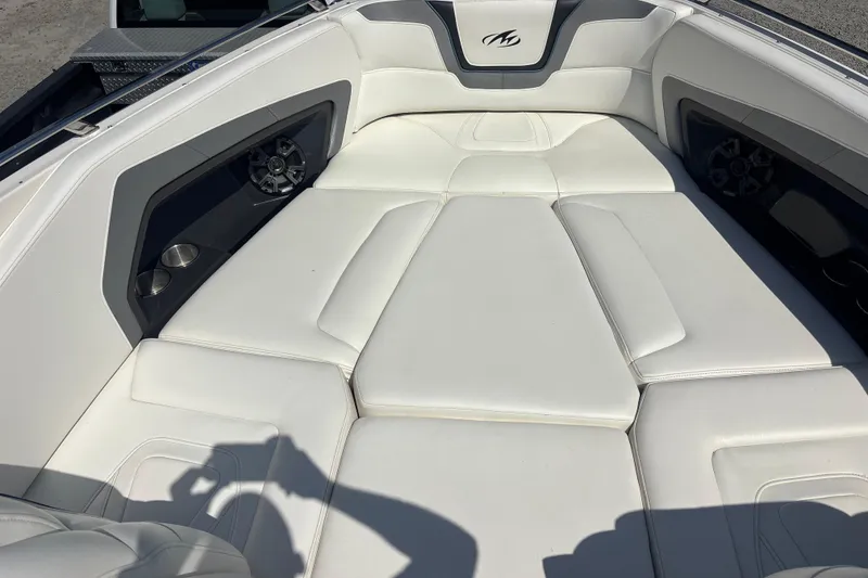 Slide: The Image of Interior of a 2014 Monterey 328SS Super Sport boat with white cushioned seating. - 30