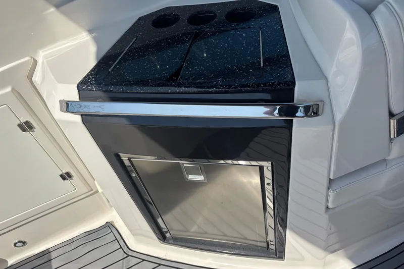 Slide: The Image of 2014 Monterey 328SS Super Sport boat interior with sleek countertop and built-in storage. - 24